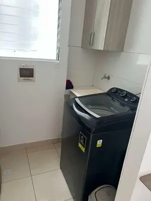 a small kitchen with a washing machine in the corner at Modern and renowned apartment in Cartagena in Cartagena de Indias