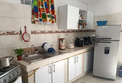 a kitchen with a white refrigerator and a sink at Habitacion privada y central in Barranquilla