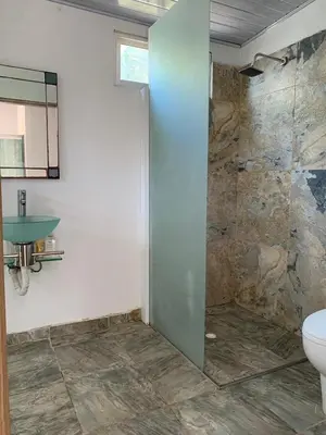 a bathroom with a shower with a toilet and a sink at House Las Palmas villa privada in Puerto Colombia
