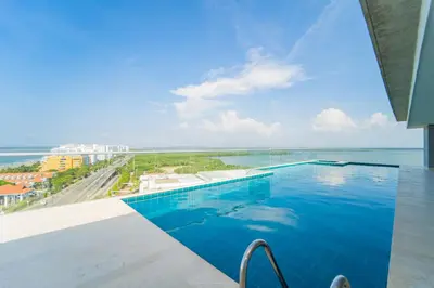 a swimming pool with a view of the ocean at 2H Encanto rentals at Sunno Beach in Cartagena de Indias