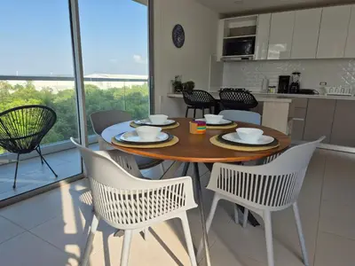 a dining room table and chairs in a kitchen at 2H Encanto rentals at Sunno Beach in Cartagena de Indias