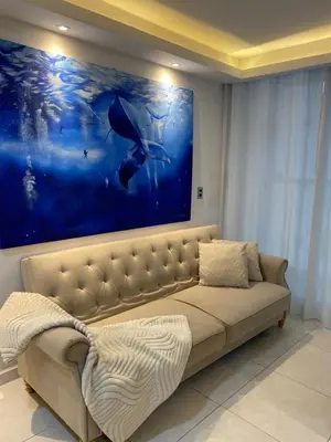 a couch in a room with a large painting on the wall at Premium stay in a central area with parking in Cartagena de Indias