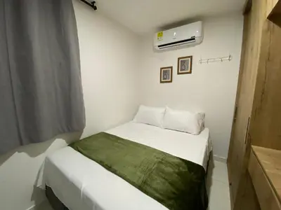 a small bedroom with a bed in a room at Premium stay in a central area with parking in Cartagena de Indias