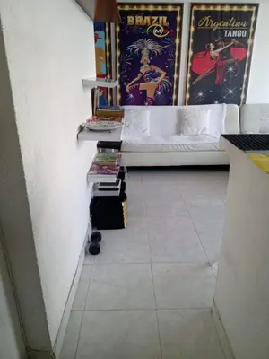 a room with a bed and a table with books at APARTAESTUDIO Con Espectacular Vista in Cartagena de Indias