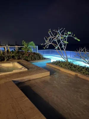 a swimming pool at night with a tree in the middle at Luxury Ocean View Aparment in Cartagena de Indias