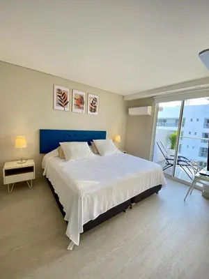 a bedroom with a large bed with a blue headboard at Luxury Ocean View Aparment in Cartagena de Indias