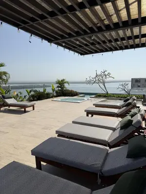 a row of chaise lounges on a patio at Luxury Ocean View Aparment in Cartagena de Indias