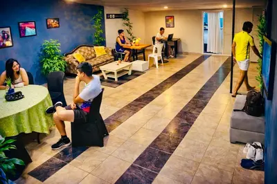 a group of people sitting in a living room at Habitaciones CALA Capsulas en Ciudad Jardín, desayuno incluido in Barranquilla