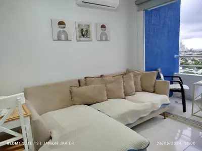 a living room with a couch and a window at walled city of Cartagena 20 in Cartagena de Indias