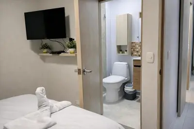 a bathroom with a bed and a toilet and a television at walled city of Cartagena 20 in Cartagena de Indias