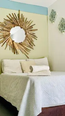 a bedroom with a bed with a mirror on the wall at Wonderland Cartagena in Cartagena de Indias