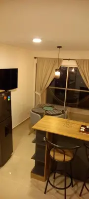 a room with a table and a kitchen with a dining room at Apartamento en Torices in Cartagena de Indias