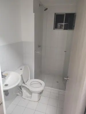 a white bathroom with a toilet and a sink at Sagitario hospedaje in Cartagena de Indias