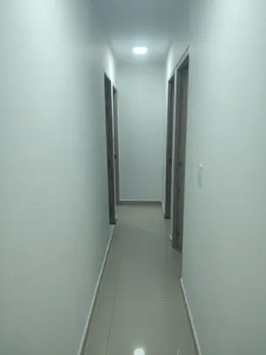 a corridor of an empty room with two doors at Sagitario hospedaje in Cartagena de Indias