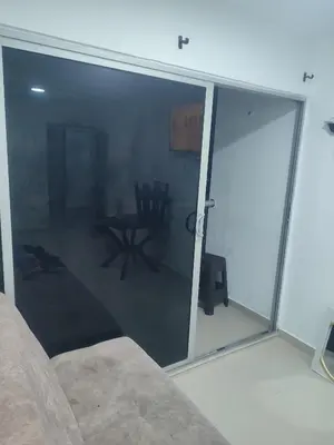 a living room with glass doors and a couch at Sagitario hospedaje in Cartagena de Indias