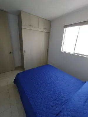 a bedroom with a blue bed and a window at New Apartment Frente al Mar, Cerca Getsemani in Cartagena de Indias