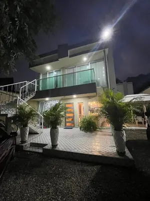 a house with potted plants in front of it at night at Lindo & Cómodo Apartamento en La boquilla in Cartagena de Indias