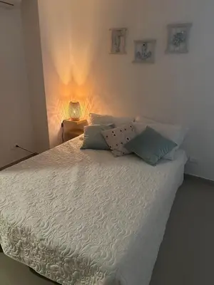 a bedroom with a white bed with two pillows at Espectacular apartamento vista al centro y al Mar in Cartagena de Indias