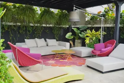 a patio with colorful furniture and plants at Casa De La Imprenta in Cartagena de Indias