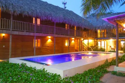 a resort with a swimming pool in front of a building at Awa de Mar Playa in Tolú