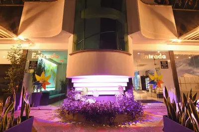 a store with purple flowers in front of a building at Hotel Florida Sincelejo in Sincelejo