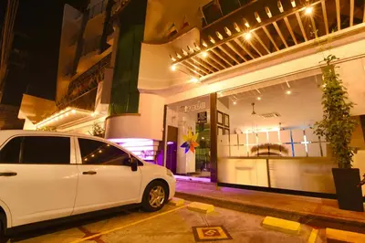 a white car parked in front of a store at Hotel Florida Sincelejo in Sincelejo