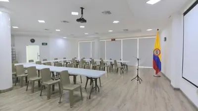 a conference room with tables and chairs and a flag at Hotel Florida Sincelejo in Sincelejo