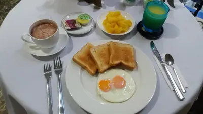 a white table with a plate of eggs and toast at Hotel Fegali Art Boutique in Cartagena de Indias