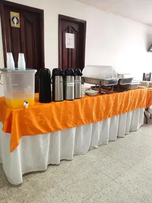 a long table with an orange table cloth at Hotel Dorado BAQ in Barranquilla