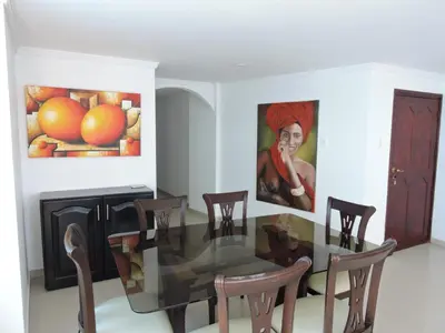 a dining room with a glass table and chairs at Apartamento Laguito Bocagrande in Cartagena de Indias