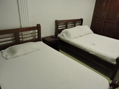 two beds sitting next to each other in a bedroom at Apartamento Laguito Bocagrande in Cartagena de Indias