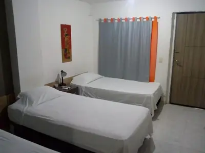 a hospital room with two beds and a curtain at Manzanillo Beach in Cartagena de Indias