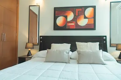 a bedroom with a white bed with two pillows at Apartamento Vista Mar 1707 in Cartagena de Indias