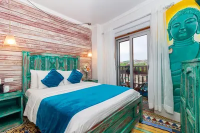 a bedroom with a large bed and a window at Voilá Signature Casa Isabel in Cartagena de Indias