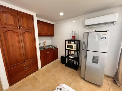 a kitchen with a white refrigerator and a microwave at Apartamento Nuevo Conquistador in Cartagena de Indias