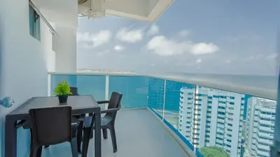 a balcony with a table and chairs on top of a building at Poseidon Lake Apartments in Cartagena de Indias
