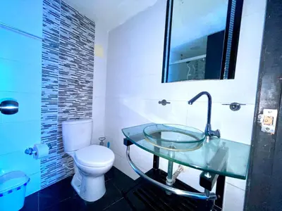 a bathroom with a glass sink and a toilet at Apartamento piso 12 y 17 Welch in Cartagena de Indias
