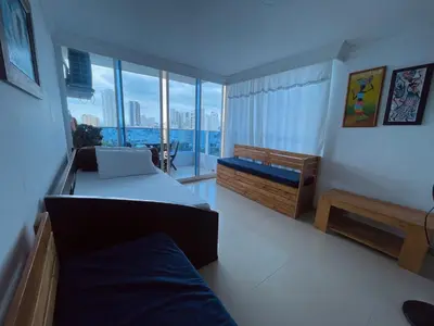 a bedroom with two beds and a large window at Cartagena El Laguito Apto cerca a la playa in Cartagena de Indias