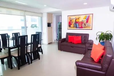 a living room with a couch and a table and chairs at Apartmento Edificio Porto Vento in Cartagena de Indias