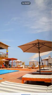 a patio with an umbrella and a pool at La Cabaña Glamping Geronimo in Playa Blanca