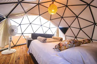 a room with a bed in a triangular shaped room at La Cabaña Glamping Geronimo in Playa Blanca