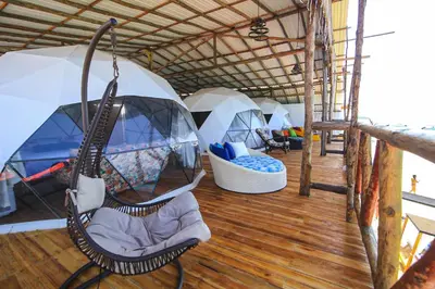 a room with tents and a hammock in it at La Cabaña Glamping Geronimo in Playa Blanca