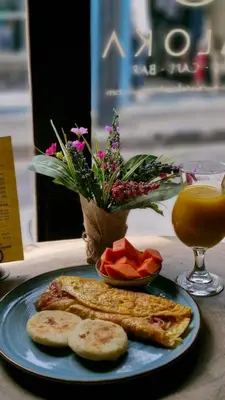 a plate of food with bread and fruit on a table at Maloka Boutique Centro Histórico in Cartagena de Indias