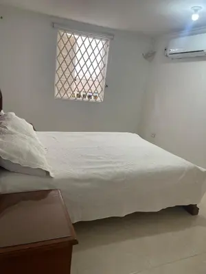 a white bed in a room with a window at Apartamento centro historico in Cartagena de Indias