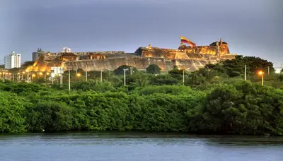 a castle on a hill next to a river at Apartamento 1904 El Laguito in Cartagena de Indias