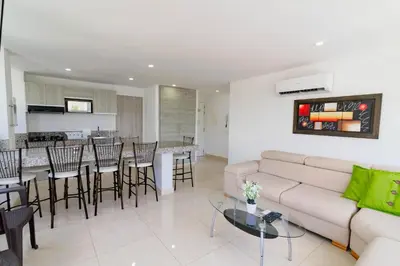 a living room with a couch and a table at Apartamento Unik Cartagena Edificio Faro Tequendama in Cartagena de Indias