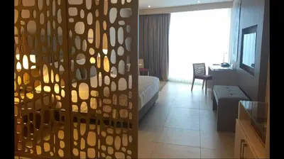 a room with a bed and a living room at Estelar Cartagena de Indias Hotel y Centro de Convenciones in Cartagena de Indias