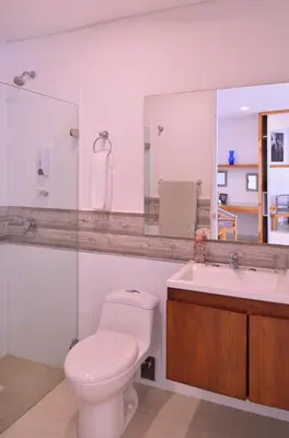 a bathroom with a toilet and a sink and a mirror at Hotel Casa Cytia in Cartagena de Indias