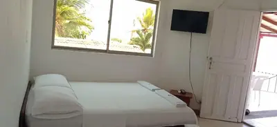 a white room with a bed and a window at Ortimar in Tolú