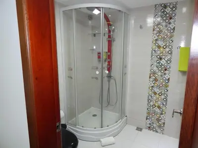 a shower with a glass door in a bathroom at Apartment Lux Bocagrande in Cartagena de Indias